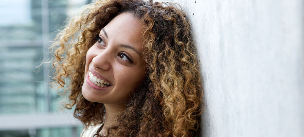 Satisfied woman smiling looking at sky