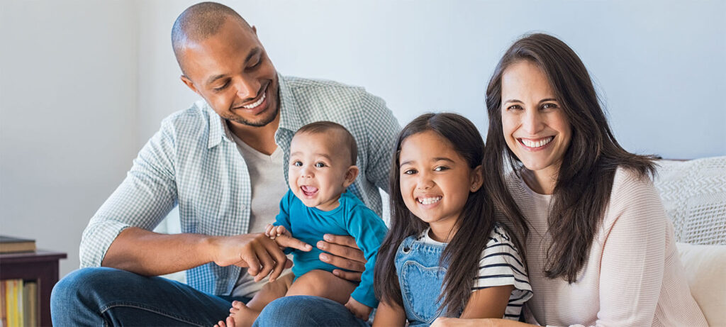 Happy family sitting on sofa at home