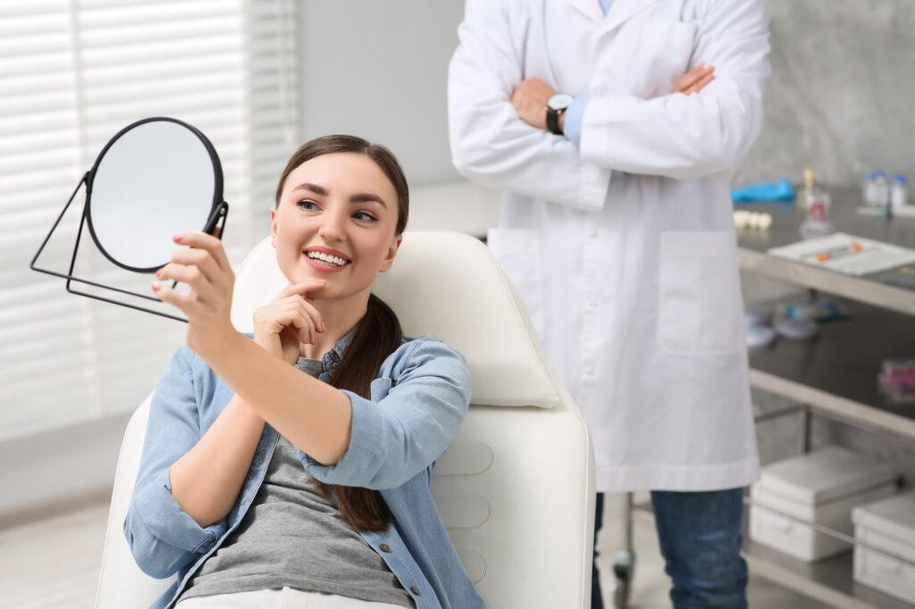 Young woman looking at her new dental implants