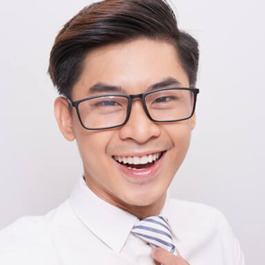 Young boy smiling wearing glasses