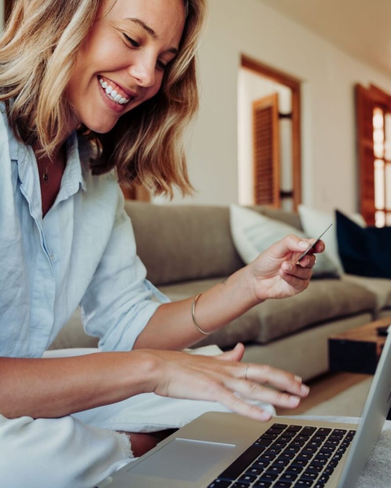 female working from home typing on laptop