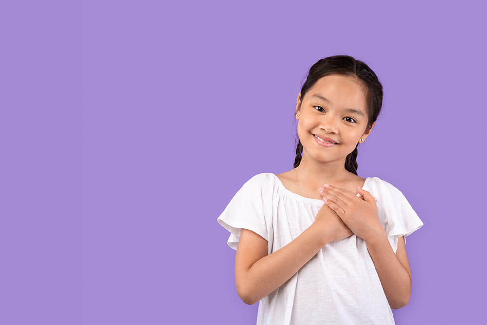 Thankful little Girl Pressing Hands To Chest Smiling