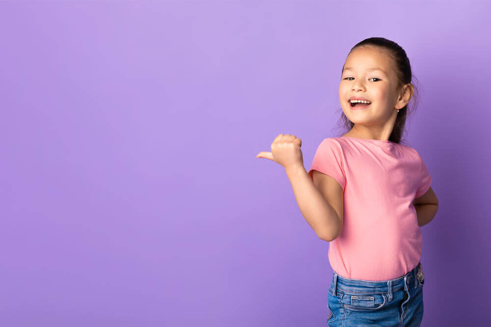 Adorable little girl pointing her finger