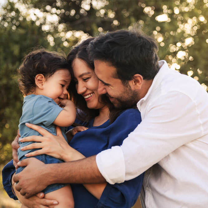 A joyful family moment with a father, mother and their one-year-old son