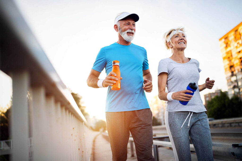 Mature couple jogging and running outdoors in city