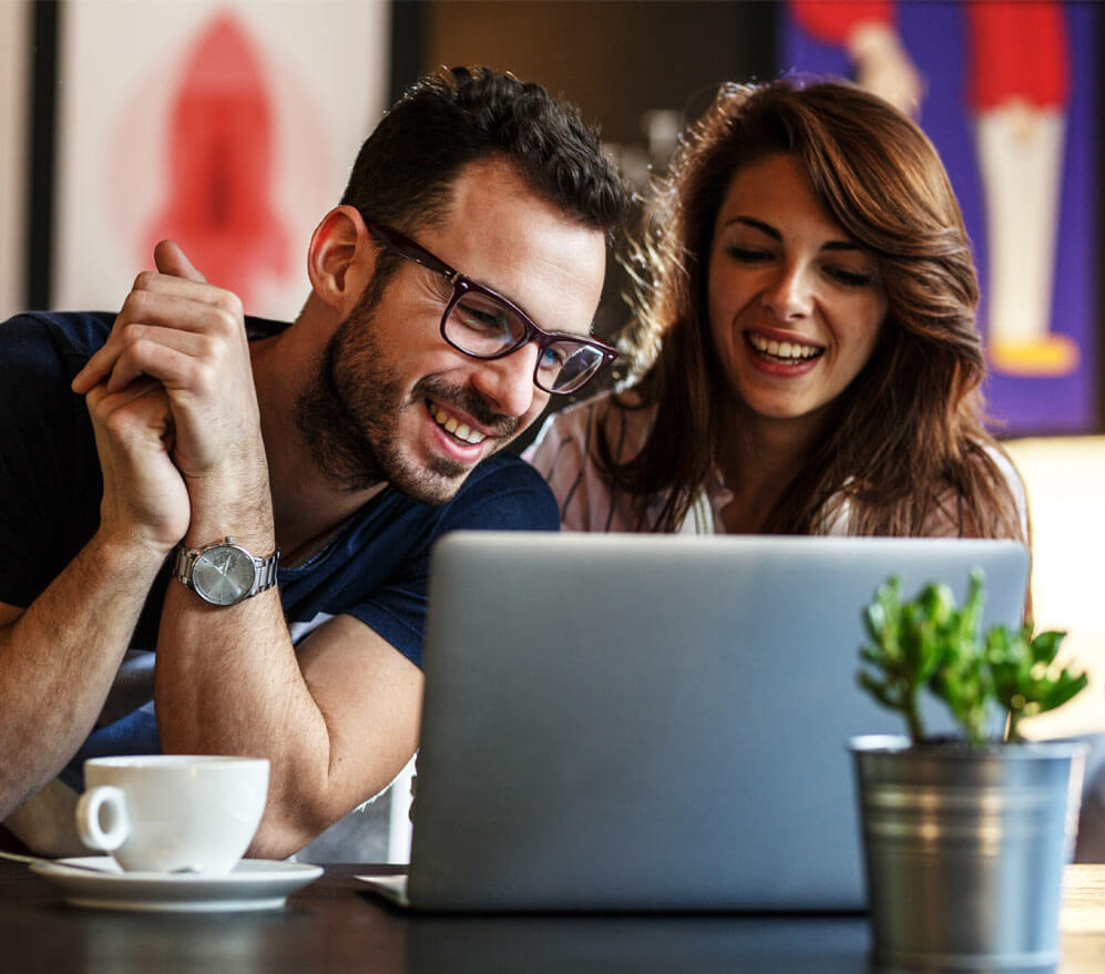 Young couple sitting at the internet cafe and relaxing