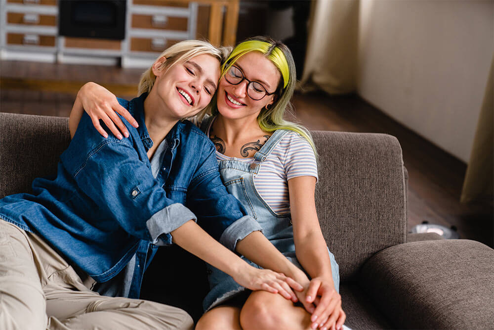 two girls hugging cuddling spending time together at home