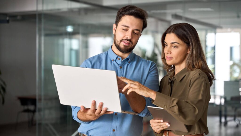 Two busy professional business people working in office