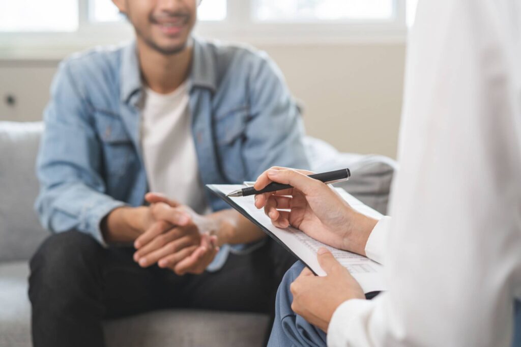 Happy smile man patient explain symptom with psychologist