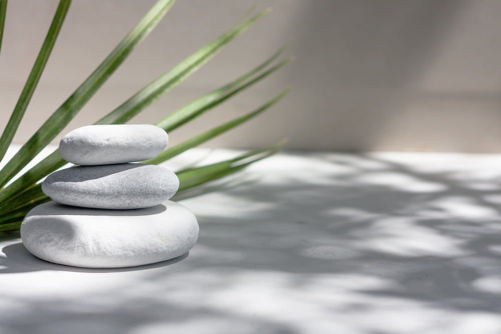 Three grey round stones and bath towels