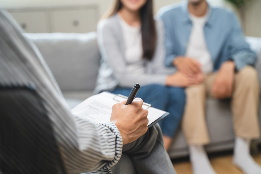 Young couple consulting problem with psychologist