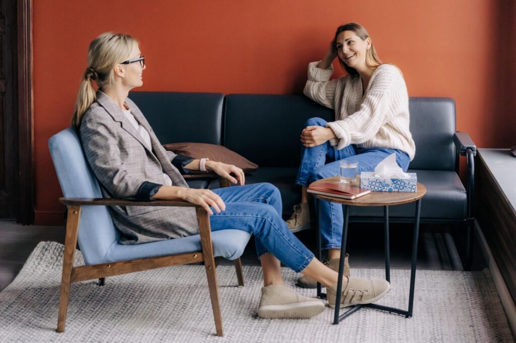 Relaxed young woman talking with therapist