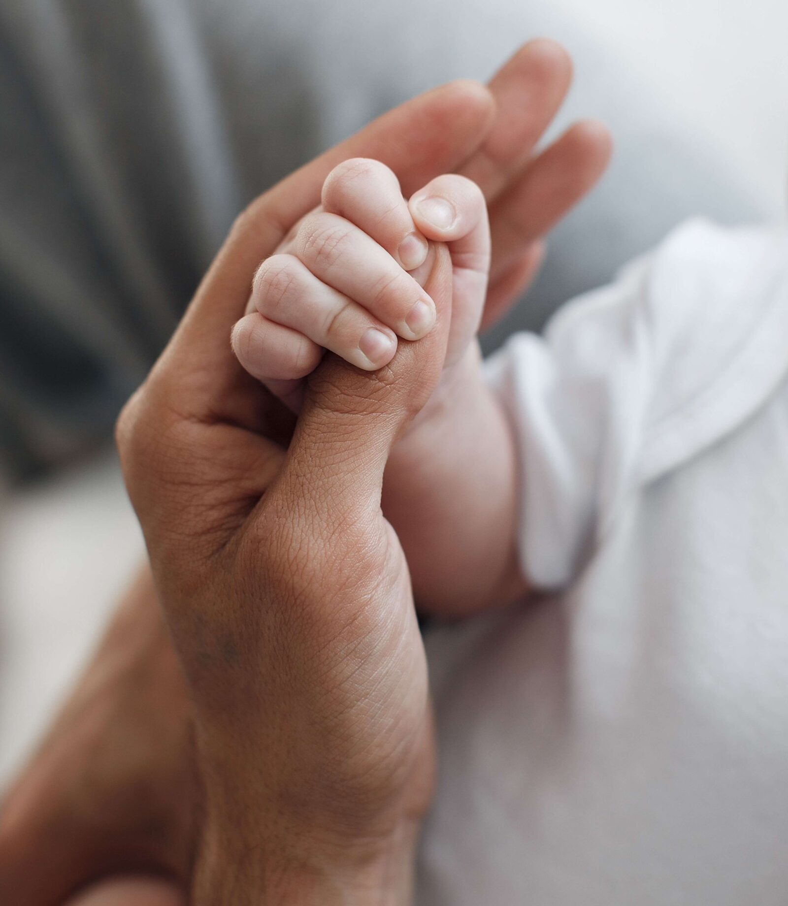 baby's hand with father's hand