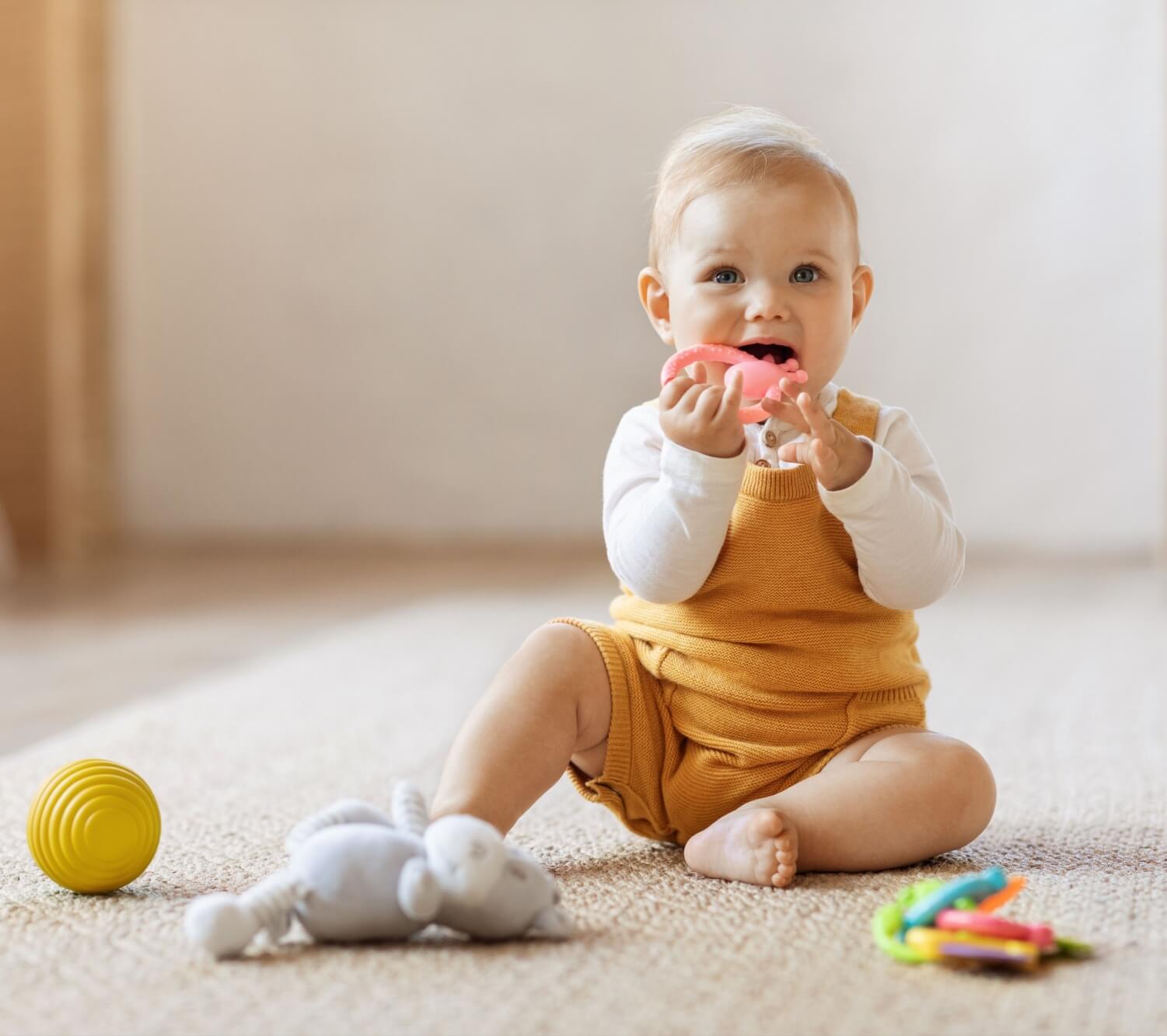 Happy cute blonde toddler baby playing with kids toys