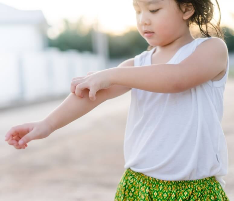 Little girl scratching an itch with hand