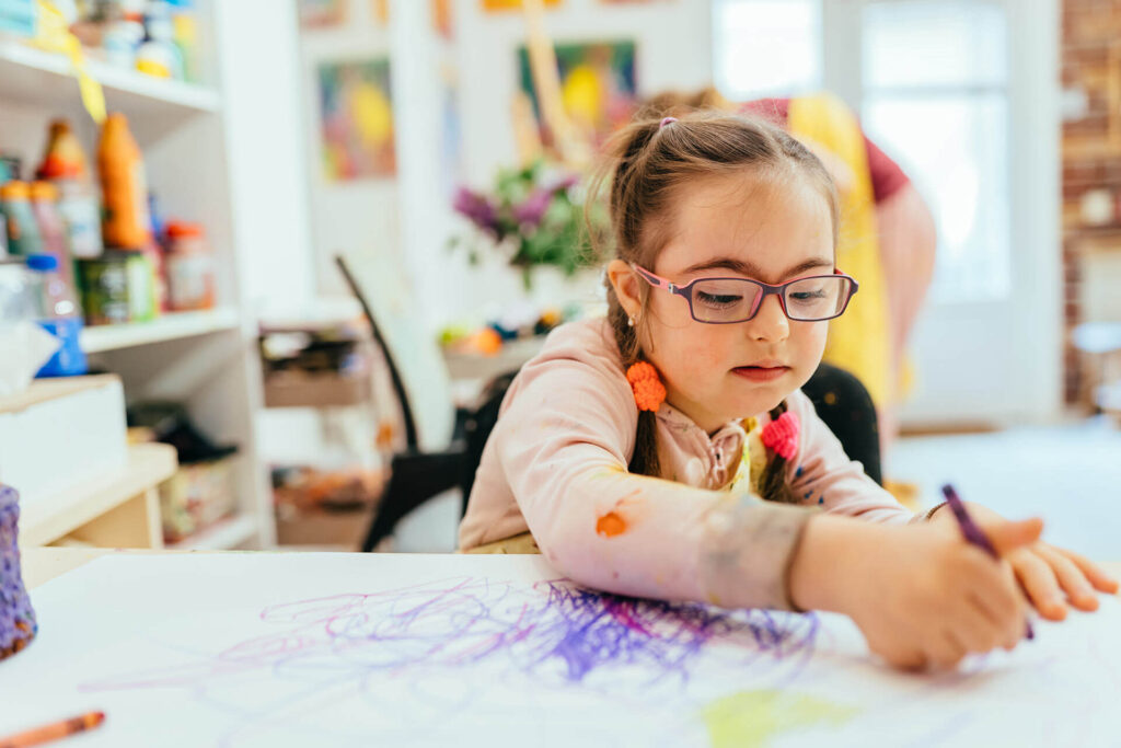 Happy Little girl doing creative project in classroom