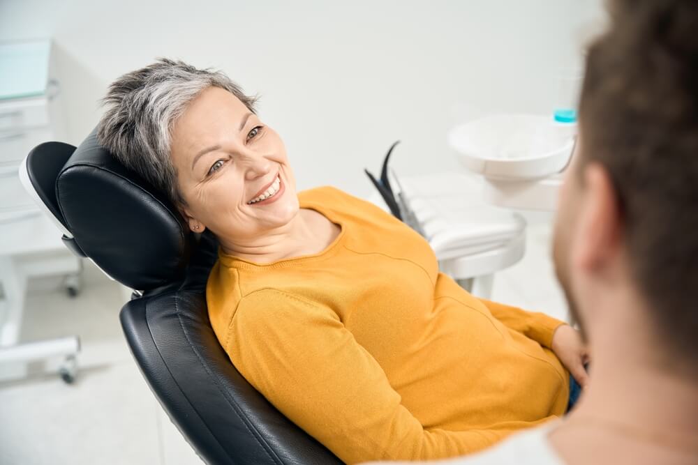 Woman client in her 50 looking at doctor