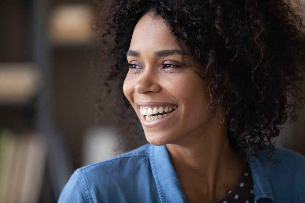 girl looking away with toothy smile