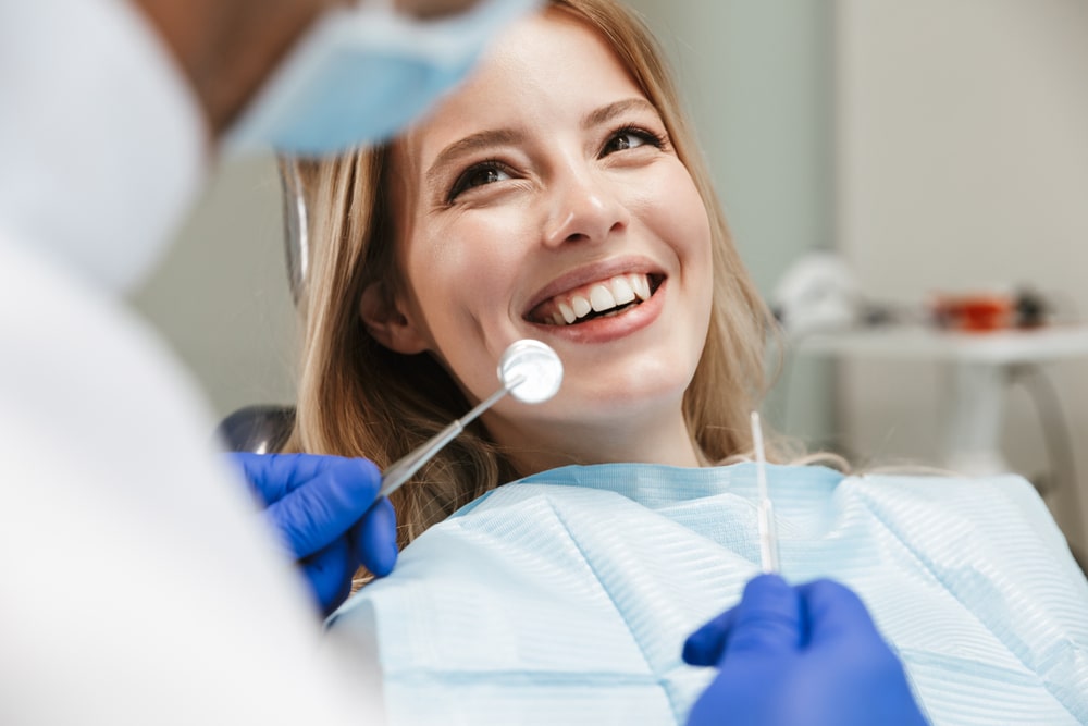 Woman sitting in dental chair at medical center