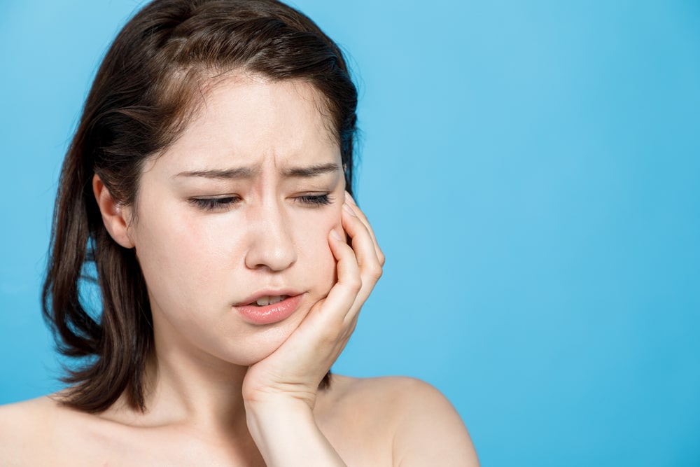 young girl getting a toothache