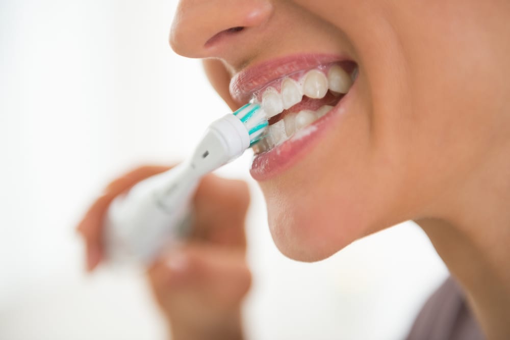Young woman brushing teeth
