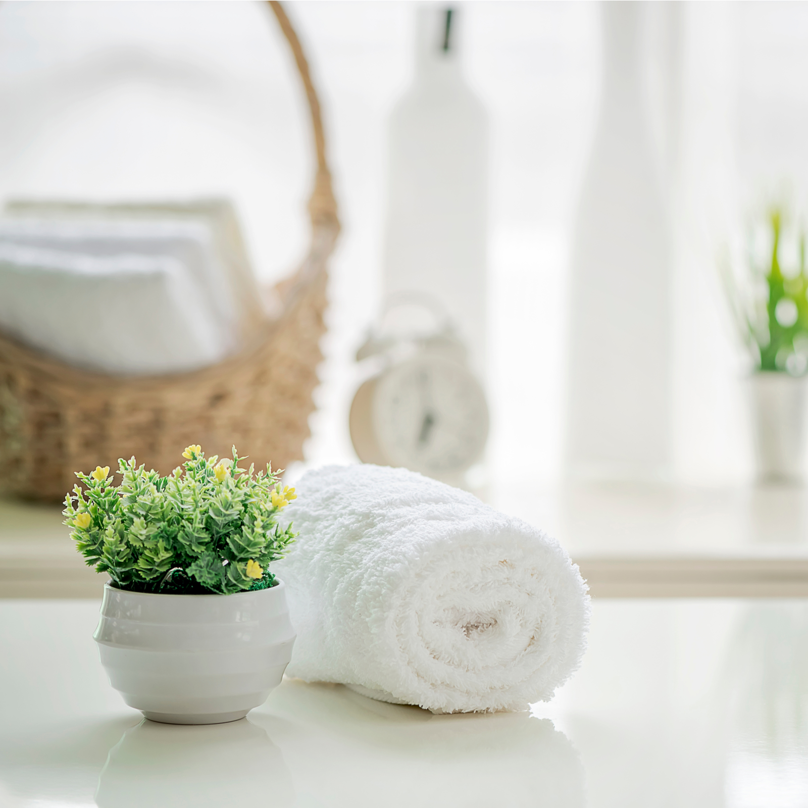 Roll up of white towels on white table