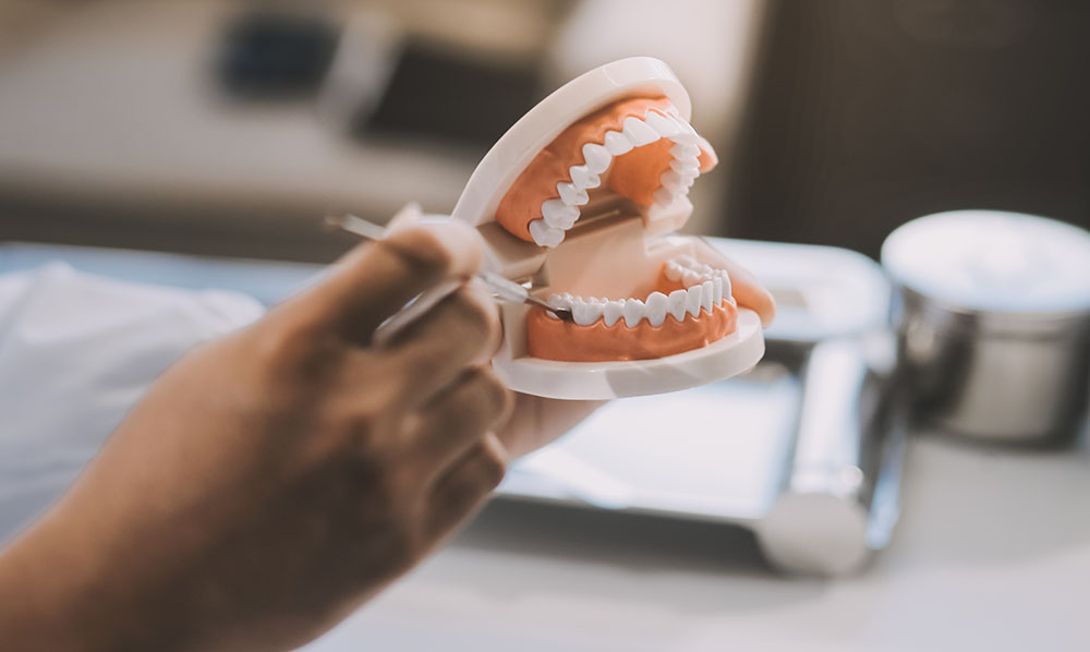 A dentist is using specialized dental equipment