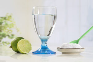 glass of water, lemon, soda bicarbonate natural solution