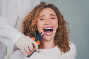 Photo of professional dentist tooth extraction emergency care afraid scared woman appointment visit medical center
