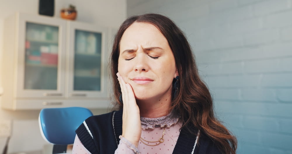 Cavity, pain and toothache with woman at dentist for appointment, checkup or extraction.