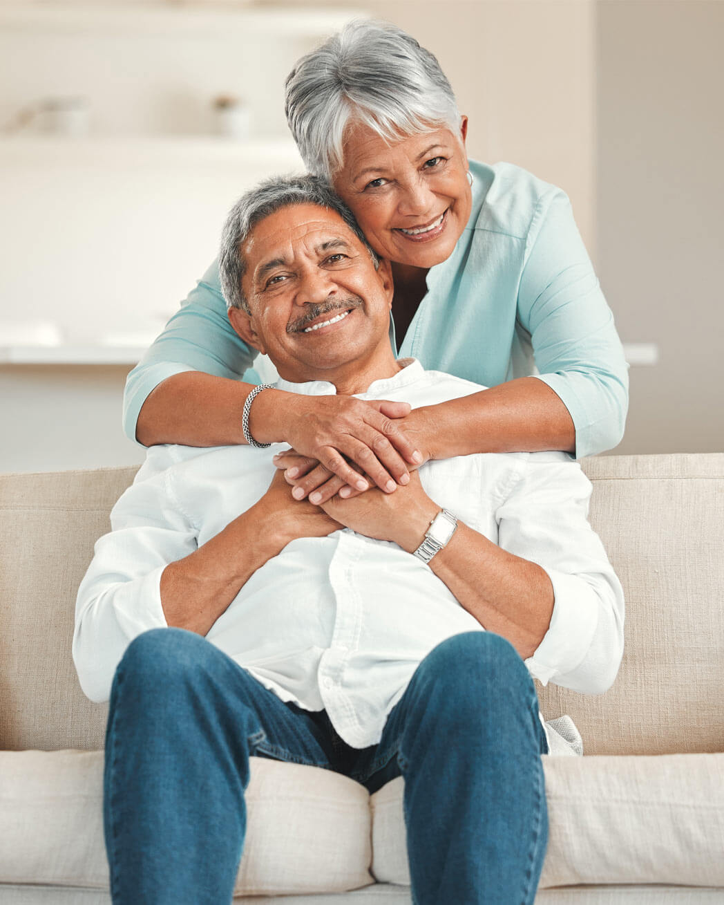 Happy senior couple relaxing on the sofa at home