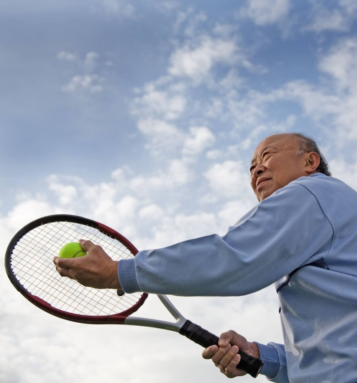 Senior man playing tennis