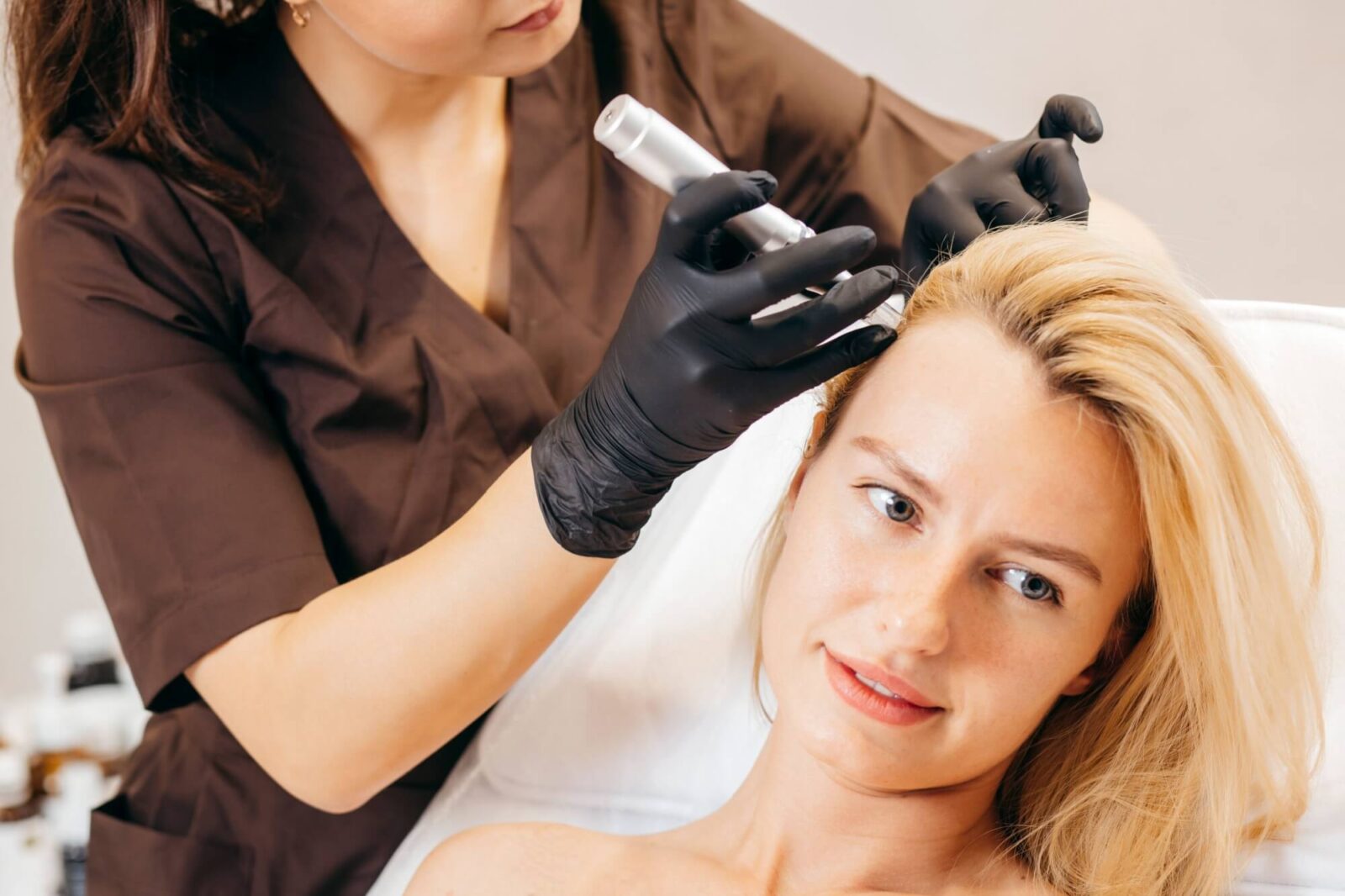 Young woman with hair loss problem receiving injection