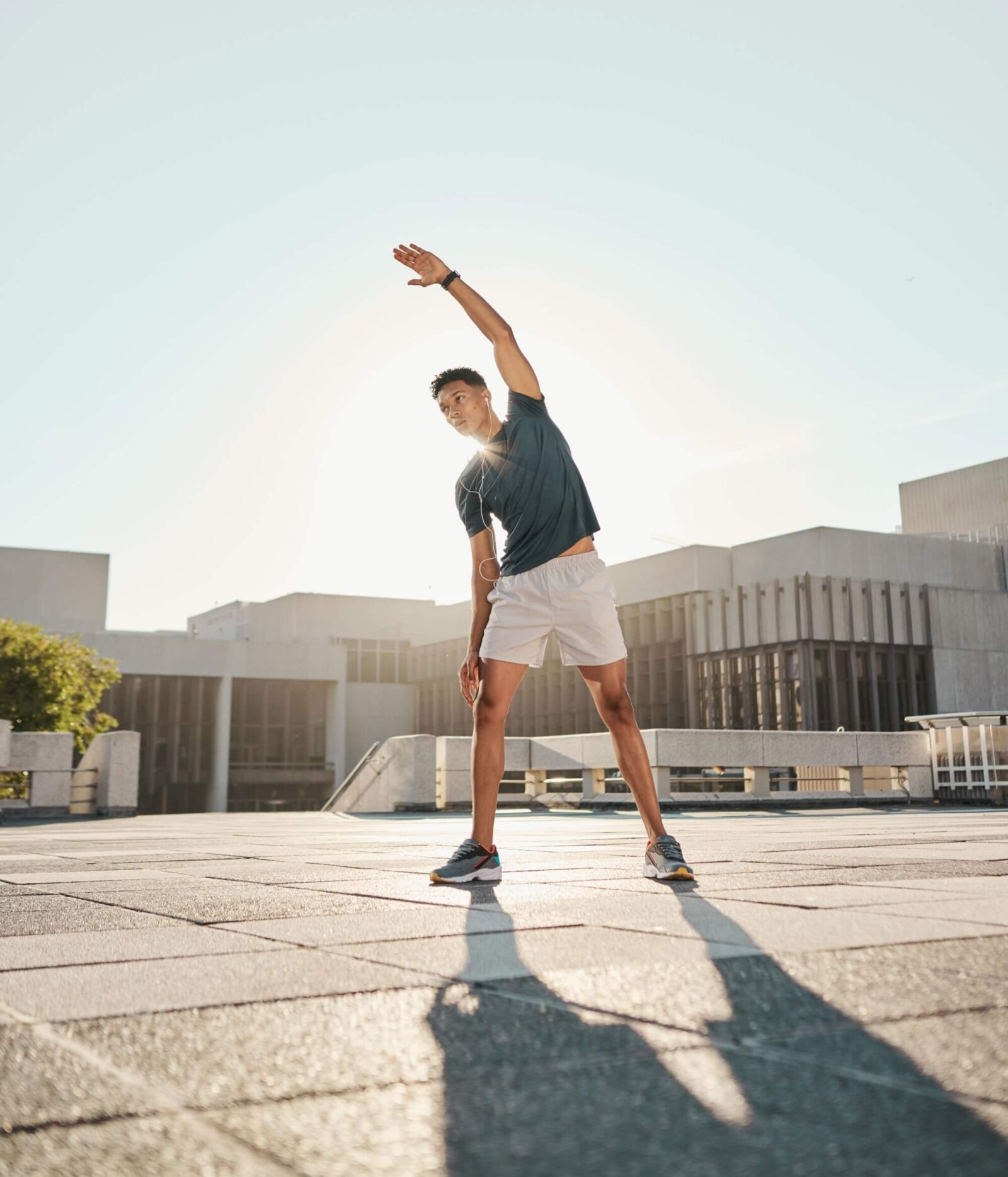 man stretching arm in the city for warm up exercise