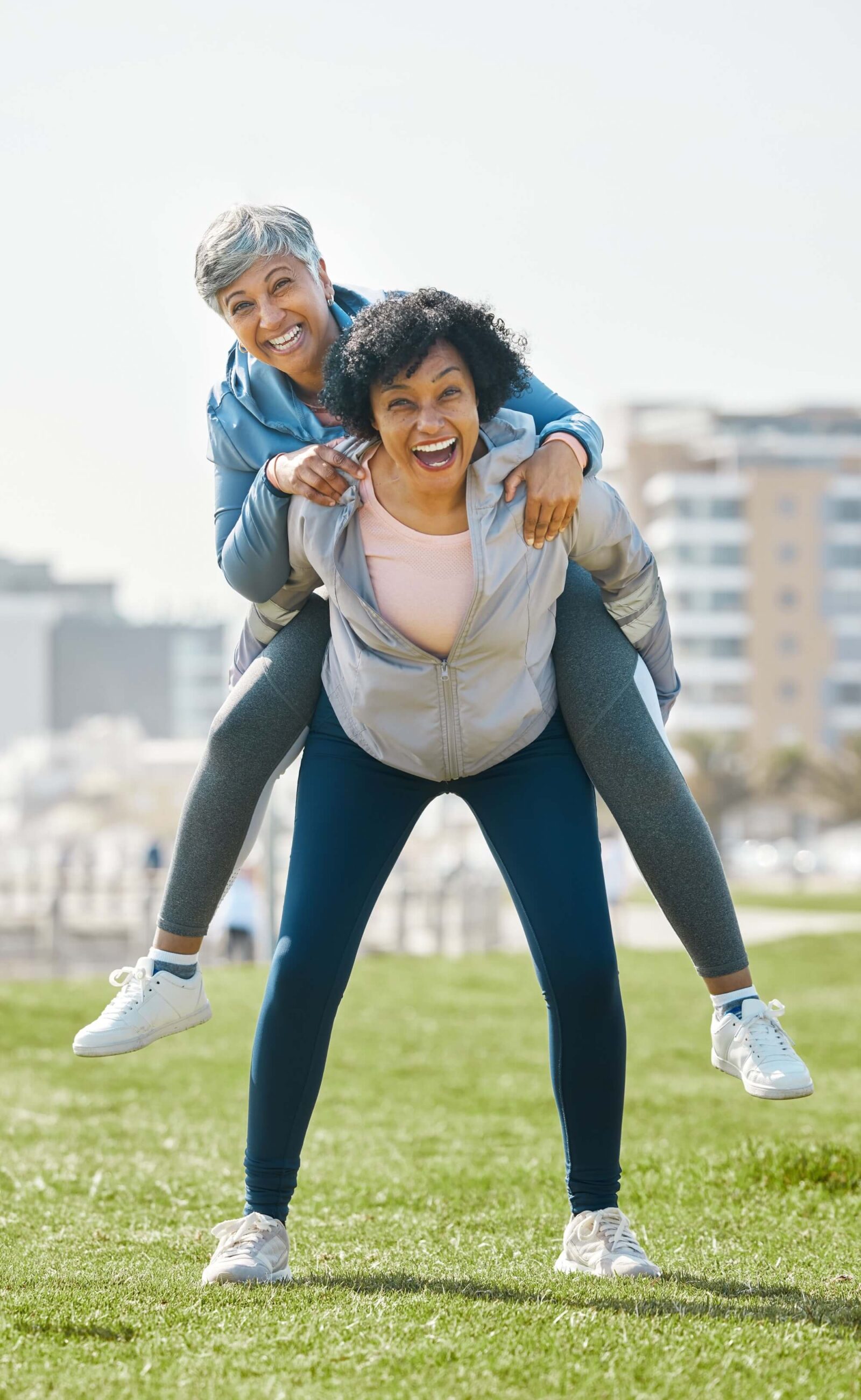 Senior women piggyback together playing