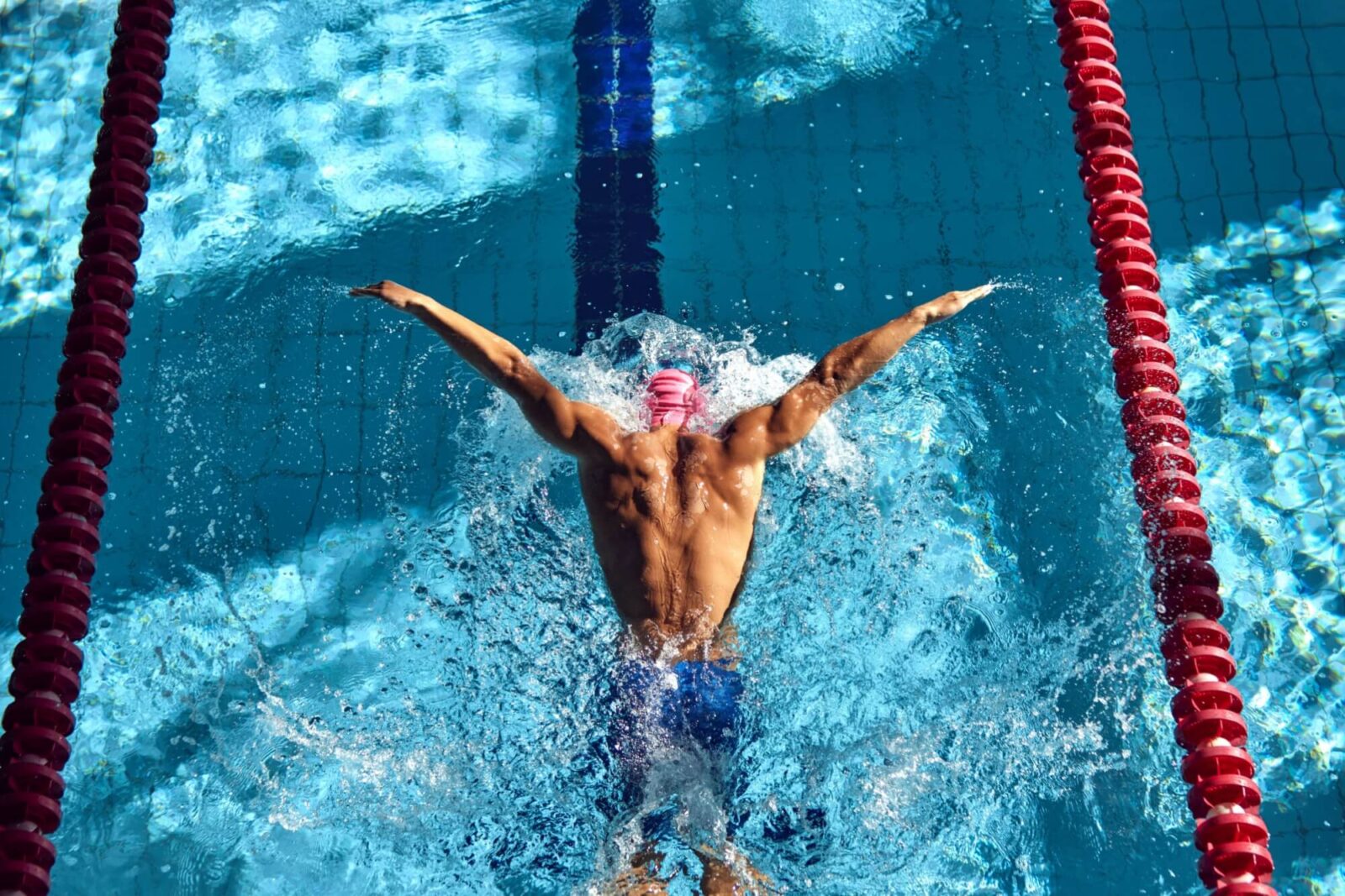 Swimmer powers through water with butterfly stroke