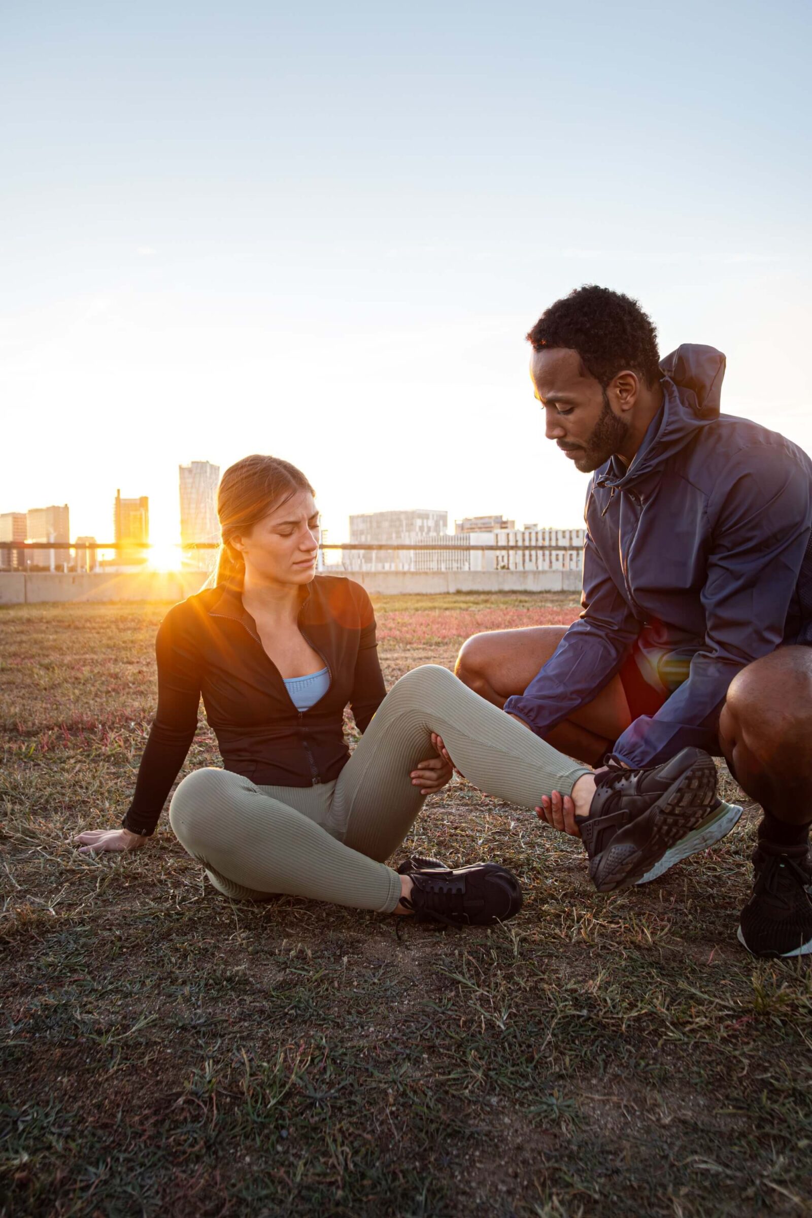 Personal trainer helping client with leg injury