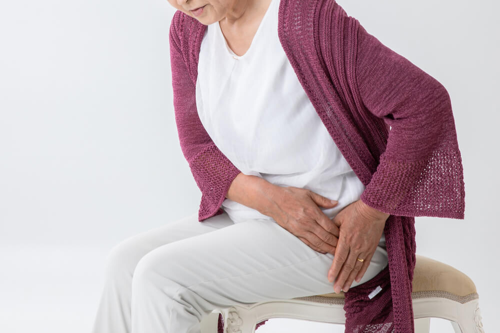 Old woman who has a pain in a hip joint