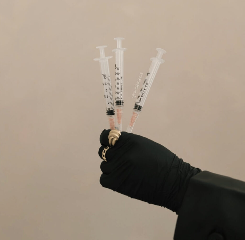 hand holding syringes