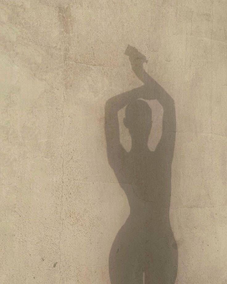 young woman shadow with hands up