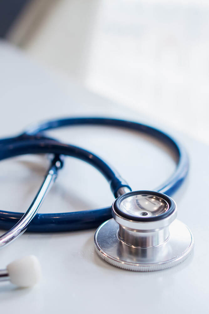 The doctor's stethoscope is placed on the table