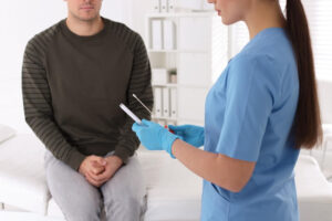 Doctor taking sample for STD testing from man