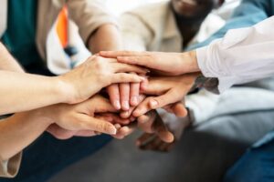 Diverse colleagues' hands unite in a powerful symbol of teamwork