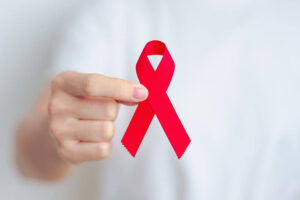 woman with Red Ribbon for December World Aids Day