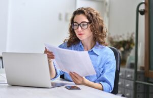 young woman looking at her insurance paperwork