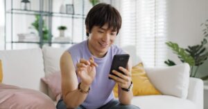 man smiling at his phone