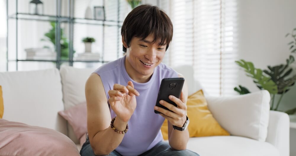 man smiling at his phone