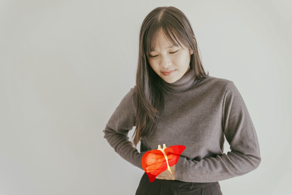 Asian young woman holding healthy liver, organ donation, hepatitis vaccination, liver cancer treatment, world hepatitis day