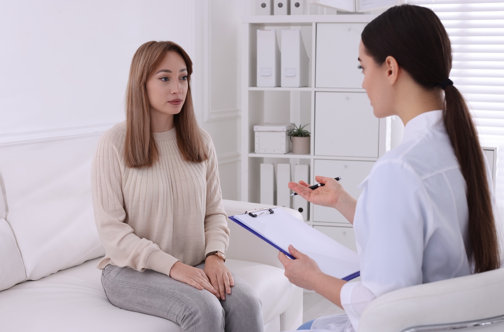 Young woman having appointment with STD specialist in clinic
