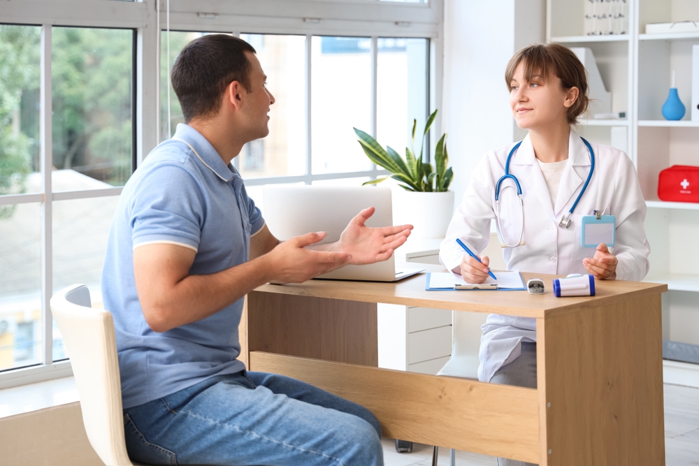 Young man visiting doctor in clinic